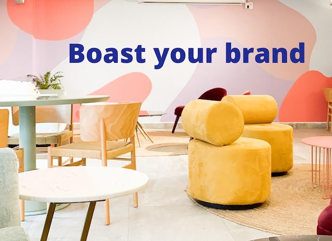 brightly coloured furniture and walls, text reads 'boast your brand' - clansman office branding wall art - clansman interiors office winter refresh